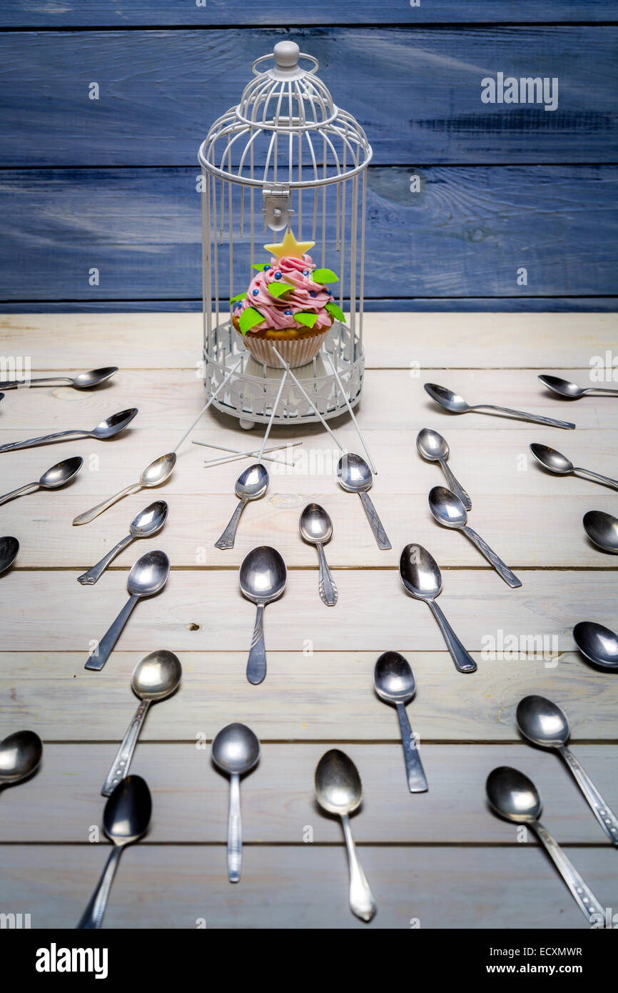 Muffin stolen by spoons Stock Photo