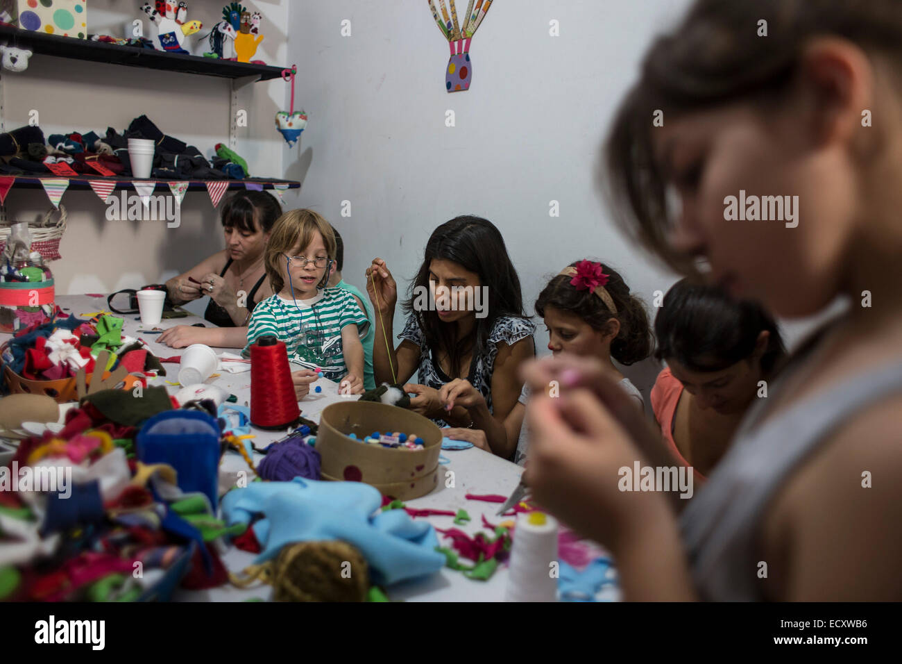 Buenos Aires, Argentina. 21st Dec, 2014. Volunteers create hand puppets that will be donated to children from low-income family in the 'Si' Foundation Toy Factory in Buenos Aires City, capital of Argentina, on Dec. 21, 2014. Up until now, over 5,600 toys created by around 6,000 volunteers have been sent to children in different cities in Argentina, according to local media. © Martin Zabala/Xinhua/Alamy Live News Stock Photo