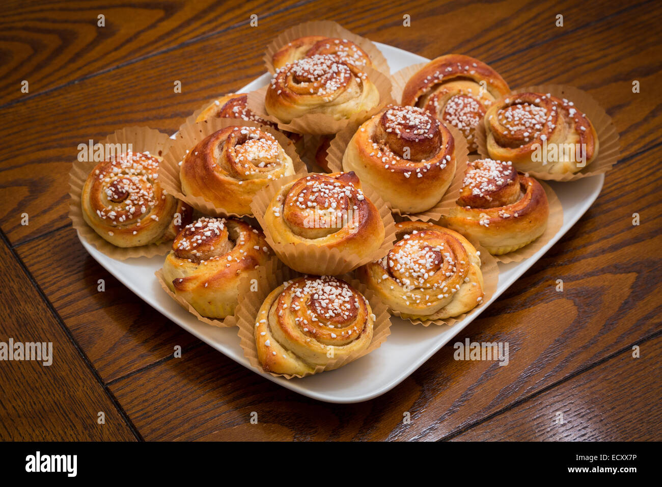 A cinnamon roll (also cinnamon bun, cinnamon swirl and cinnamon snail) is a sweet roll served commonly in Scandinavia Stock Photo