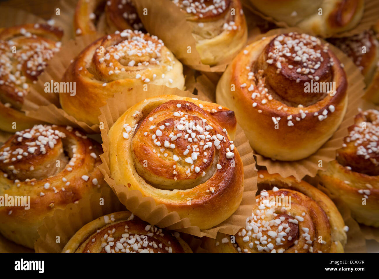 A cinnamon roll (also cinnamon bun, cinnamon swirl and cinnamon snail) is a sweet roll served commonly in Scandinavia Stock Photo