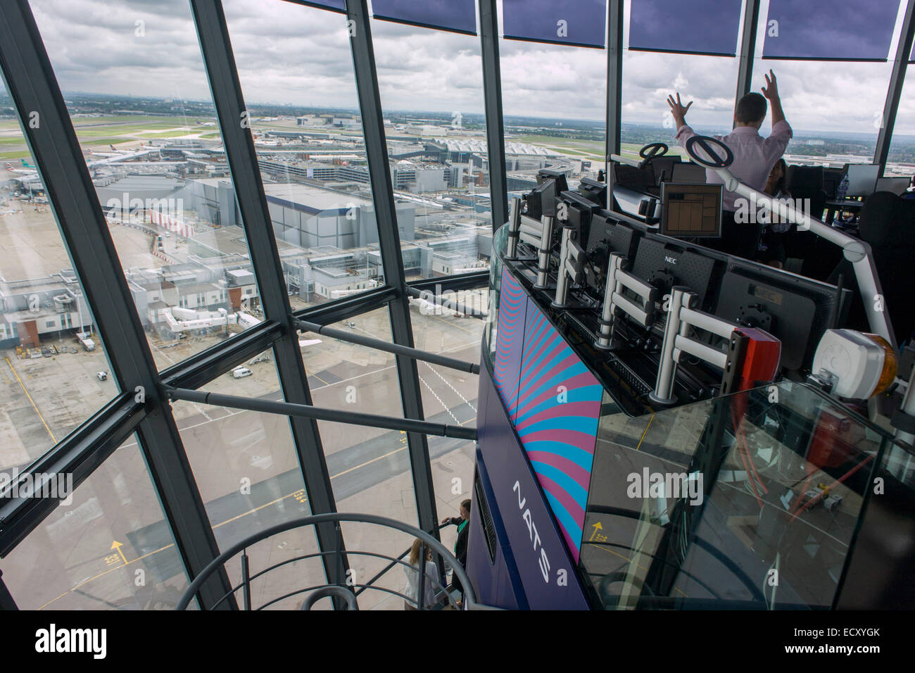 Aerial view (through control tower windows) showing NATS air traffic controllers and expanse of airport land at London Heathrow. Stock Photo