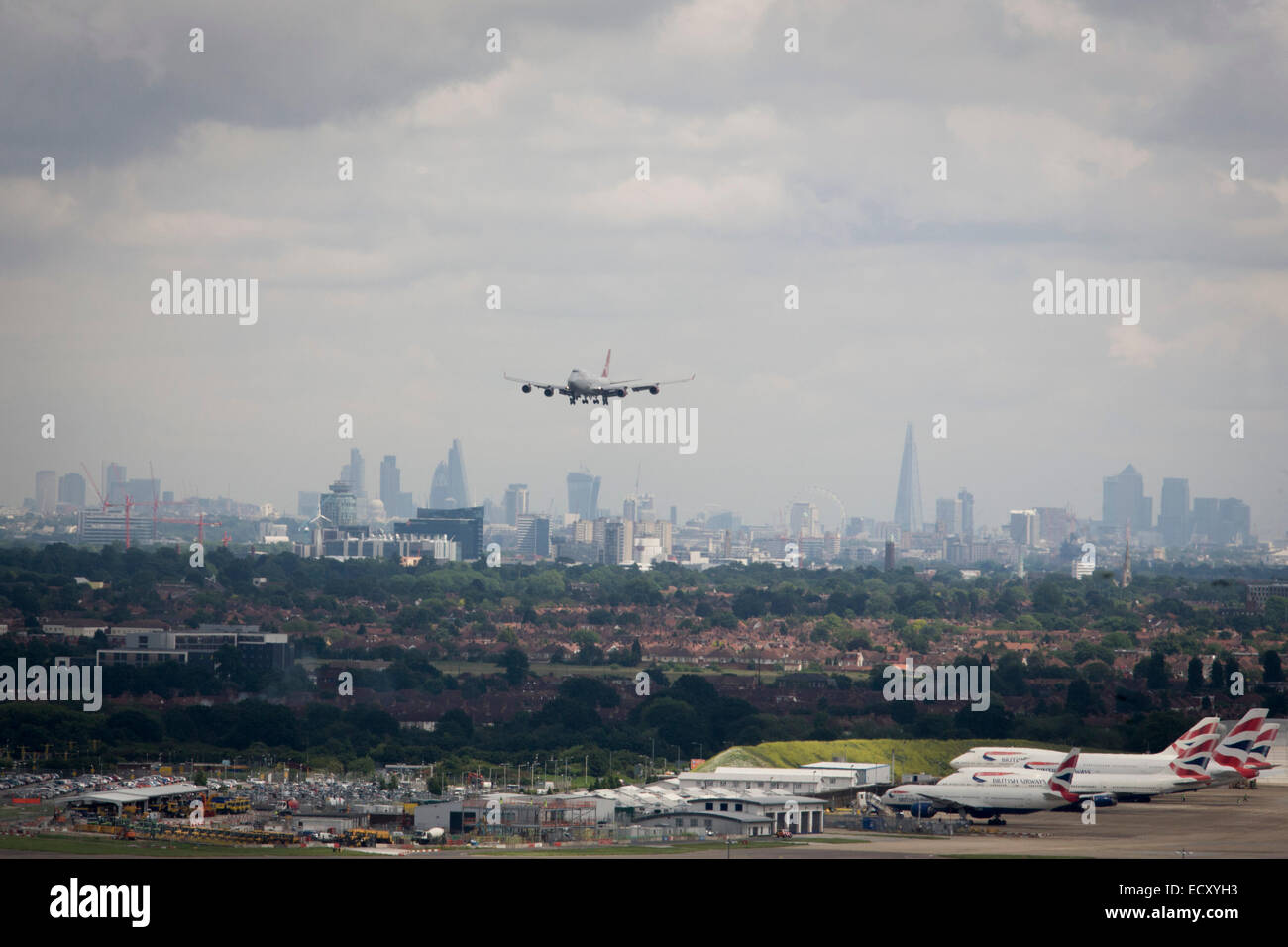Aerial view (from control tower) of landing 747 jet and showing expanse of airport land at London Heathrow. Stock Photo
