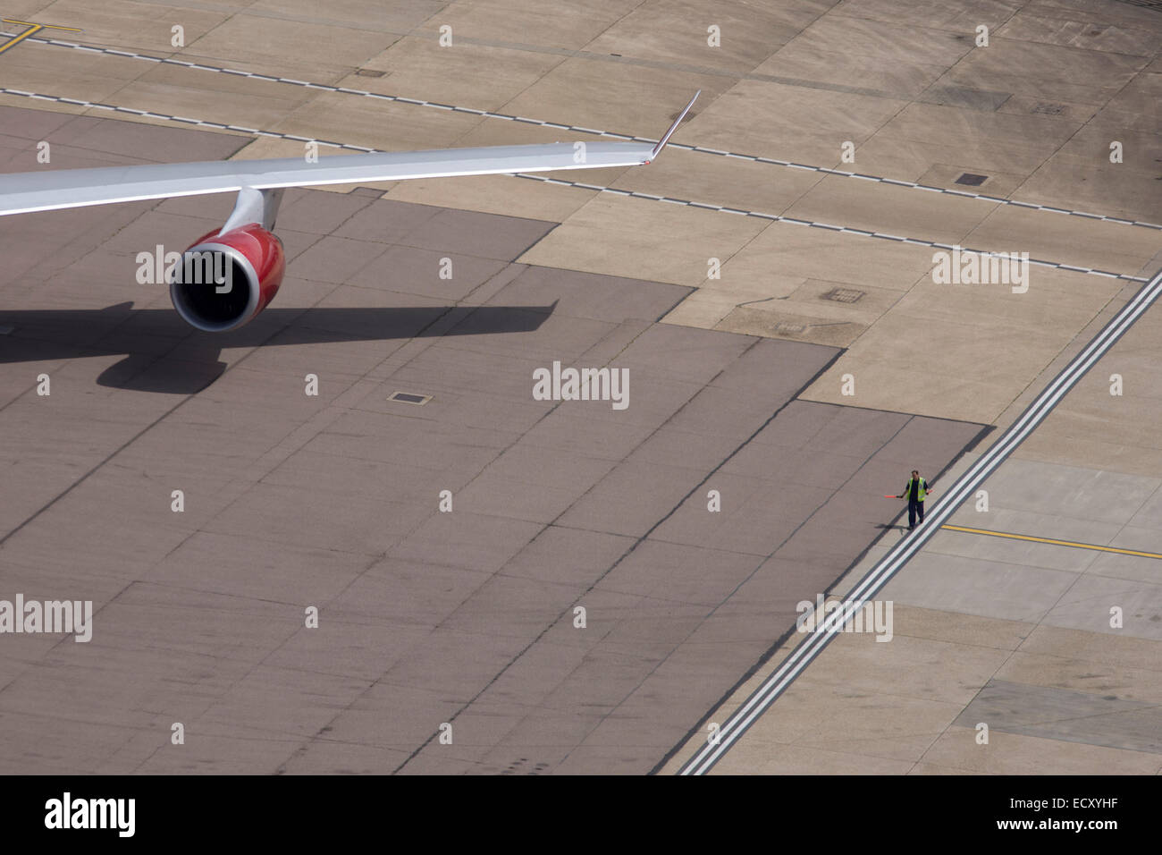 Aerial view (from control tower) of airport ramp marshal and airliner ...