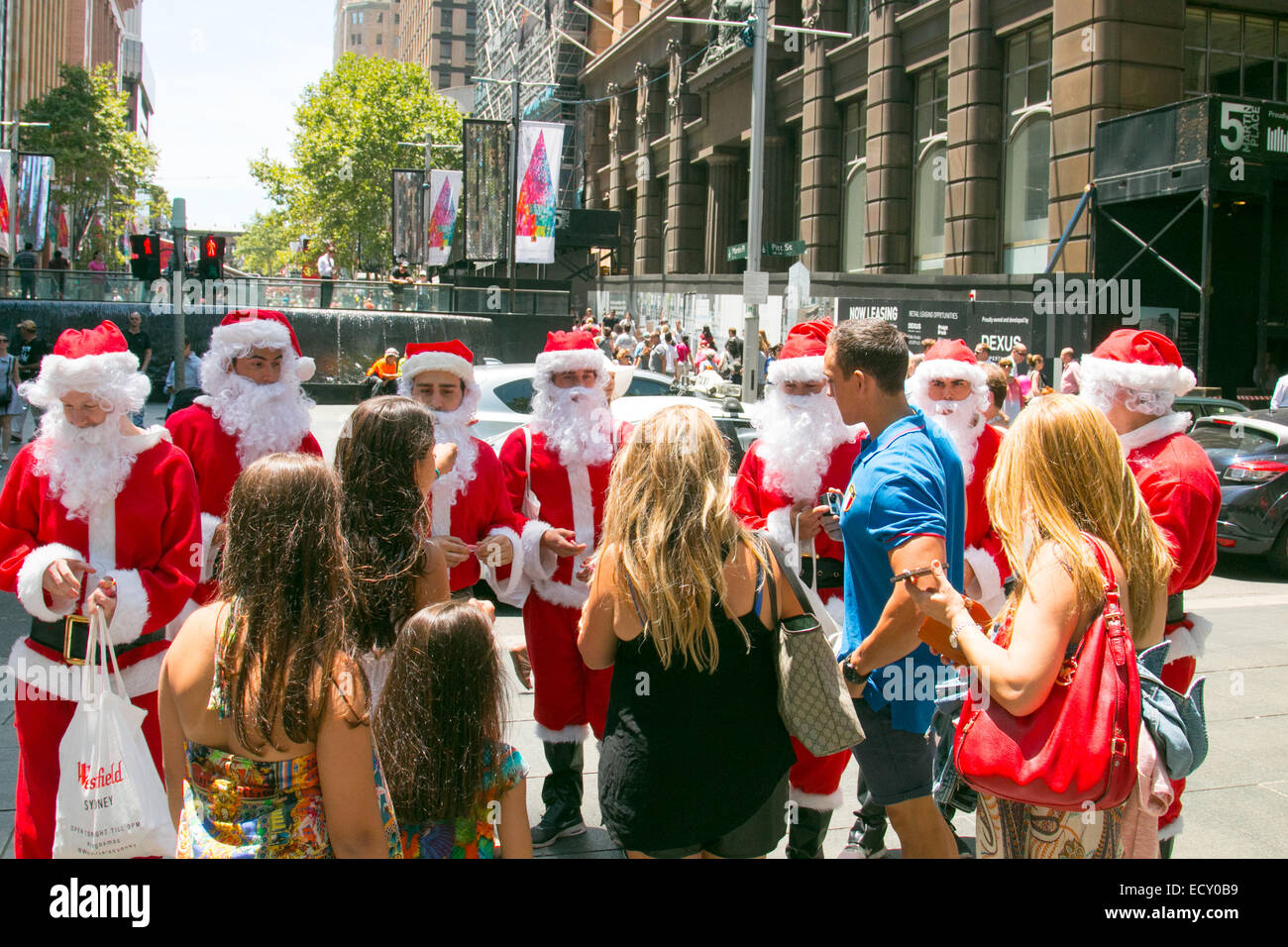 Sydney, Australia. 22nd Dec, 2014. Whilst Sydneysiders continue to leave flowers in Martin Place, the western end of the precinct plays host to the city's christmas tree and versions of Santa Claus. Credit:  martin berry/Alamy Live News Stock Photo