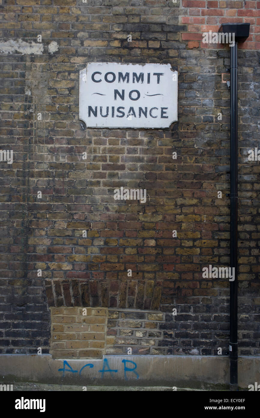 A Victorian-era 'Commit No Nuisance' sign on the wall of a south London church premises. Stock Photo