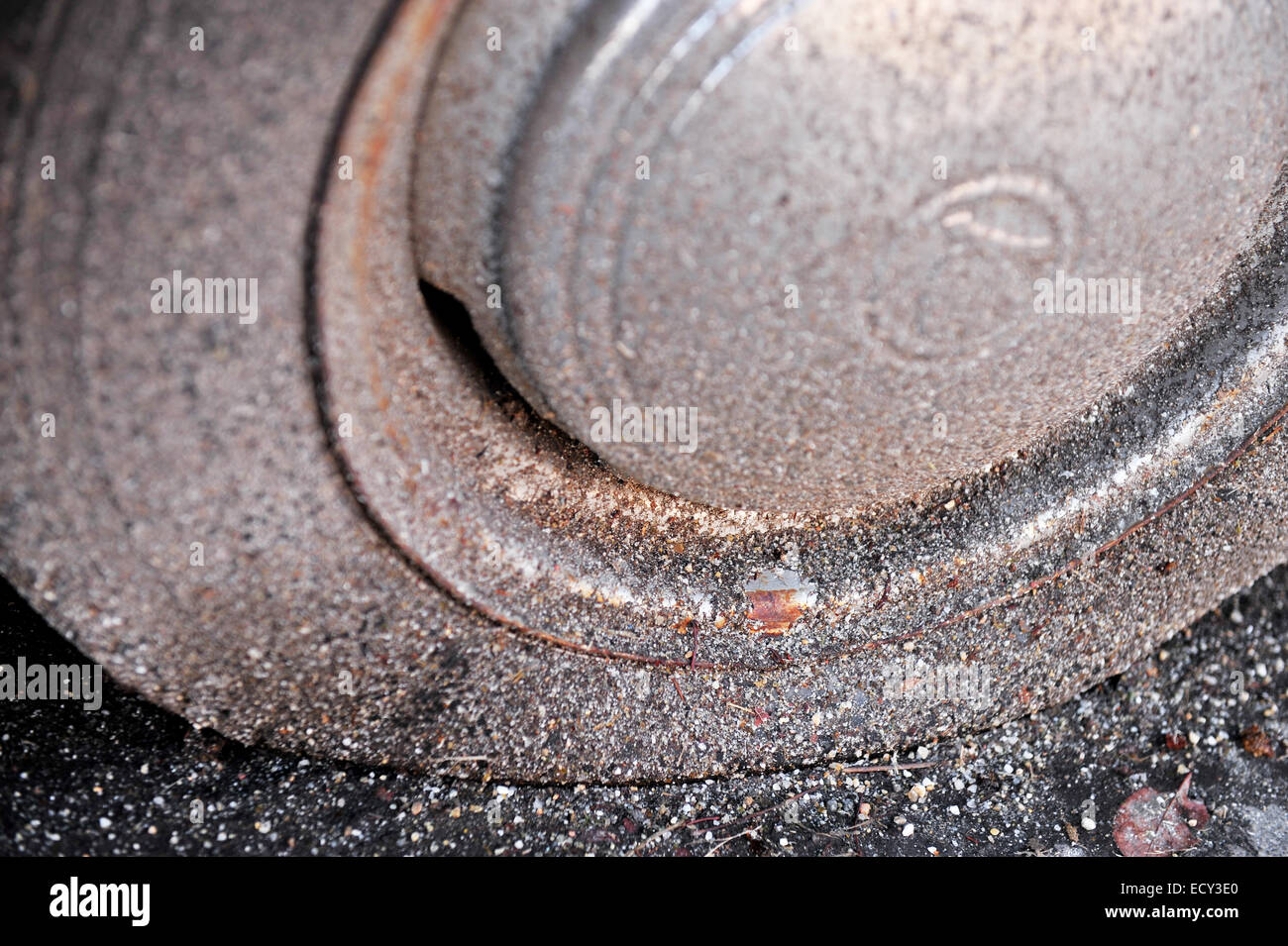Abandoned car detail with a rusty rim and a flat tire Stock Photo