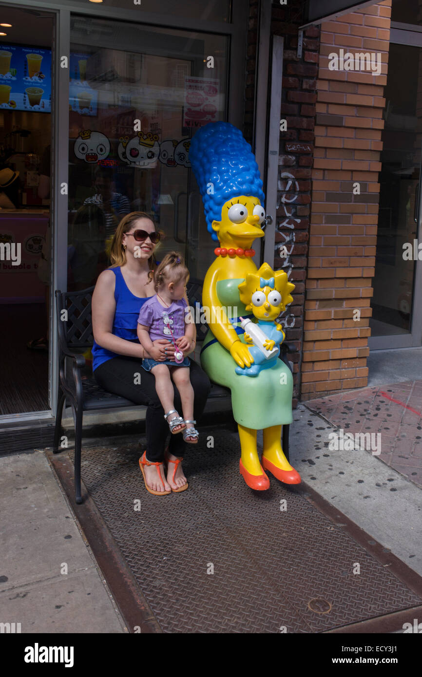 Real-life mother and child with Marge and Maggie Simpson characters. Stock Photo