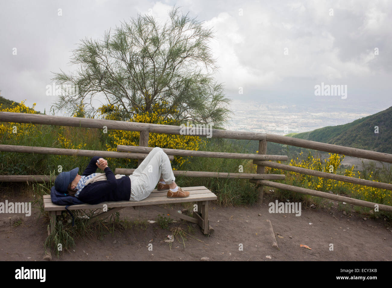 Man checks smartphone during visit to the Vesuvius volcano. Stock Photo