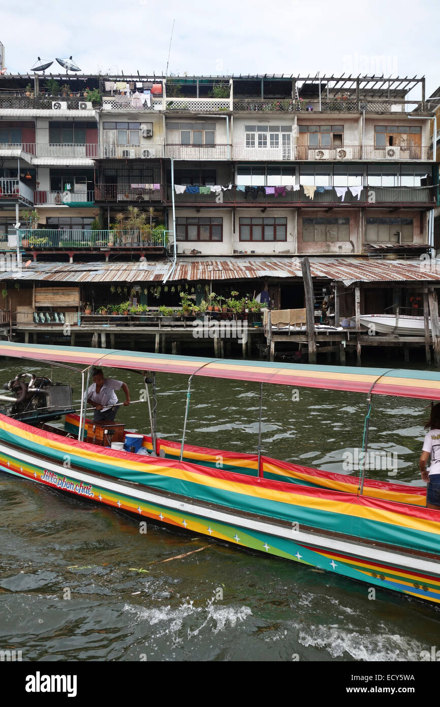 Longtail-boat with owner at Chao Phraya River, Bangkok, old houses chinatown, Thailand, Southeast Asia. Stock Photo