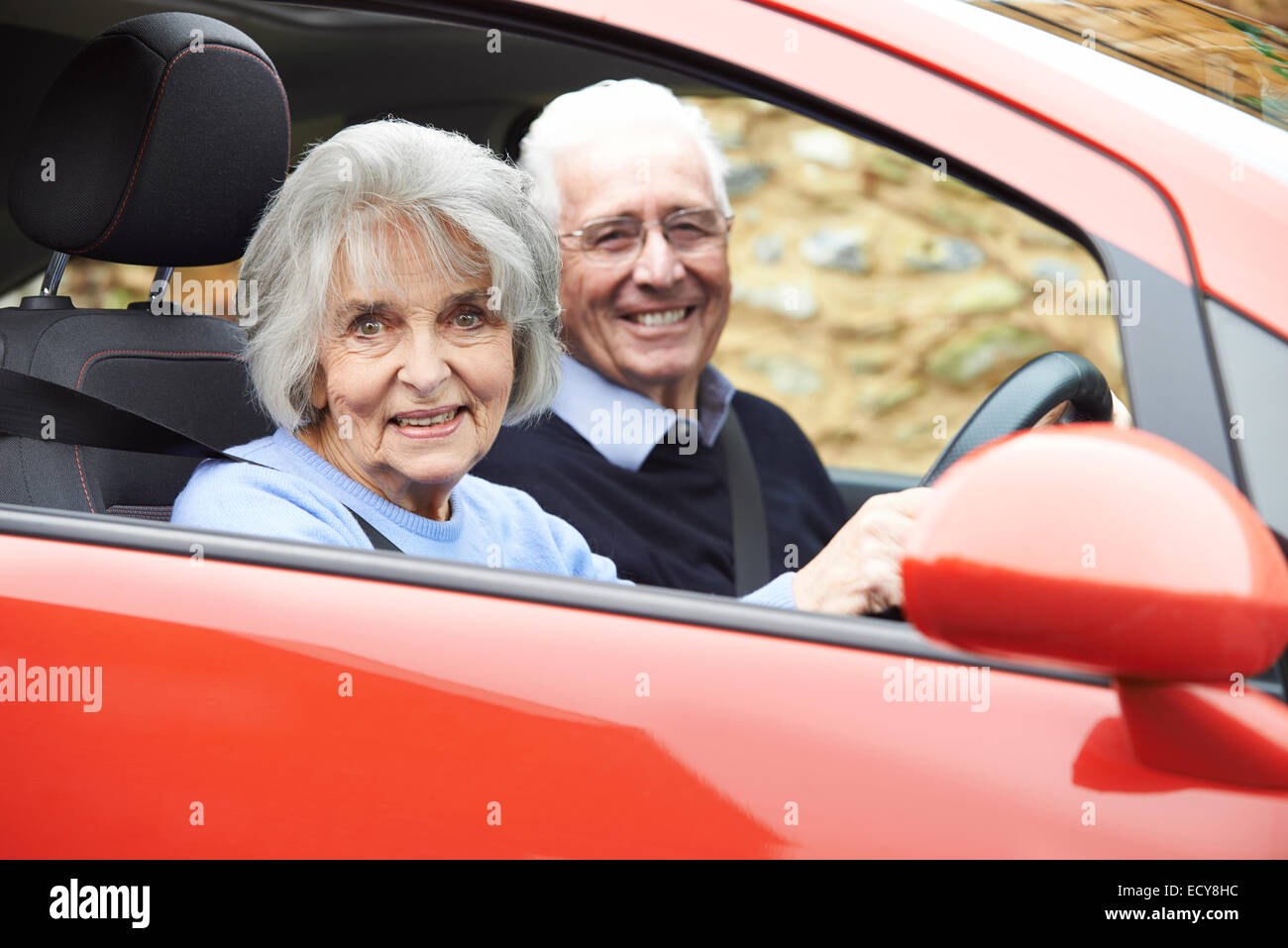 Portrait Of Smiling Senior Couple Out For Drive In Car Stock Photo