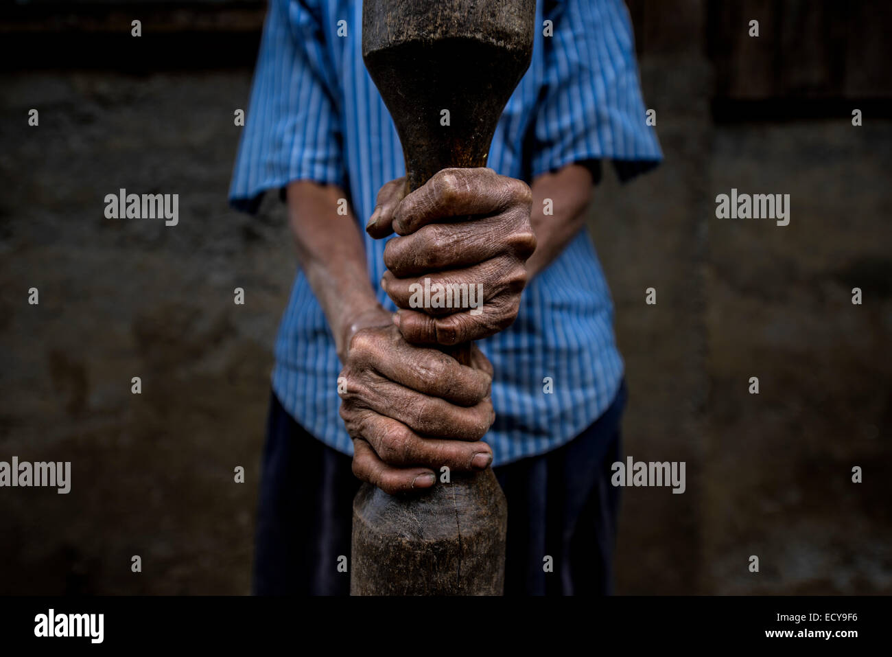 Woman holding bar for rice pounding, North Luzon, Philippines Stock Photo