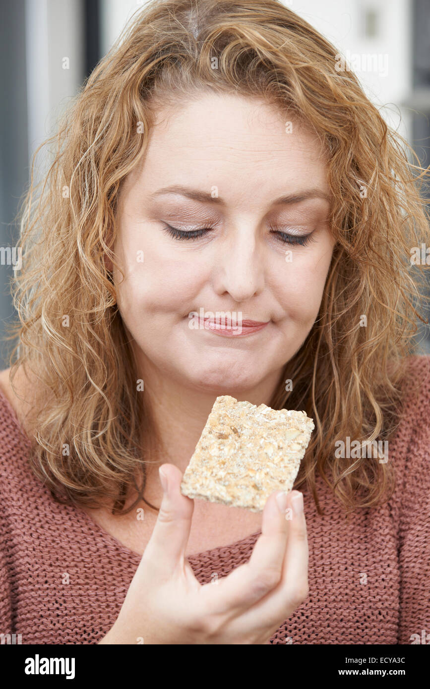Bored Woman On Diet Eating Crispbread At Home Stock Photo