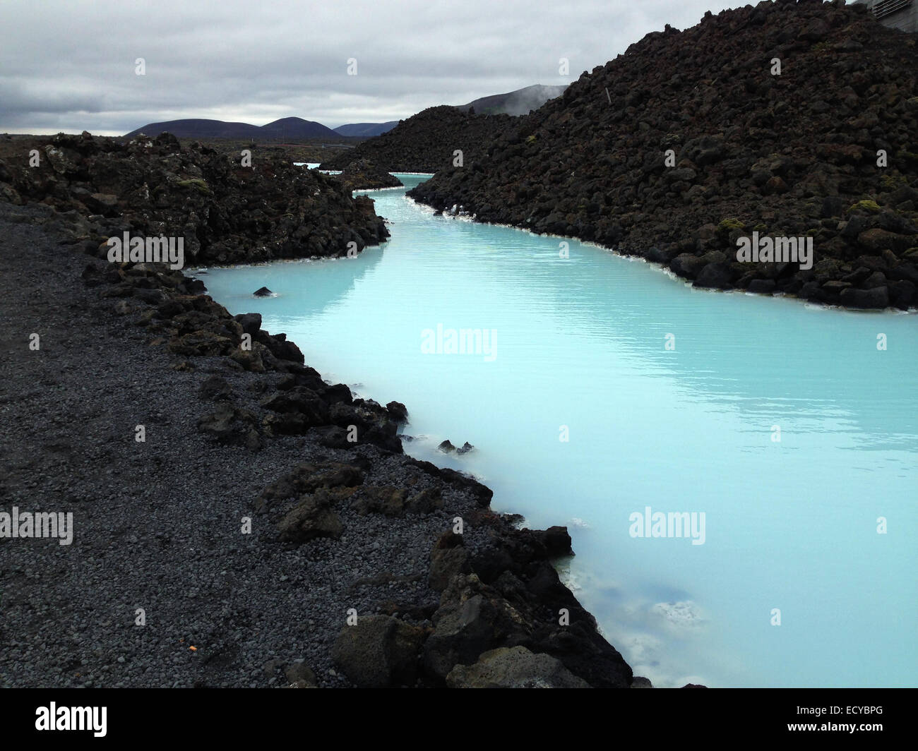 Sulfurous geothermal lake in rocky volcanic landscape - Smartphone Captured Stock Image