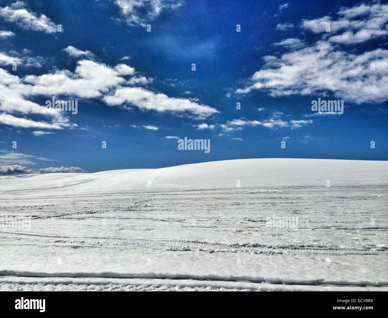 Clouds in blue sky over snowy landscape - Smartphone Captured Stock Image
