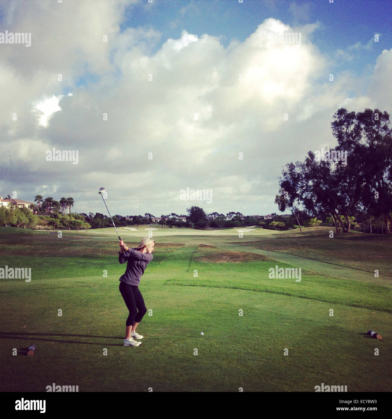 Caucasian woman playing golf on course - Smartphone Captured Stock Image
