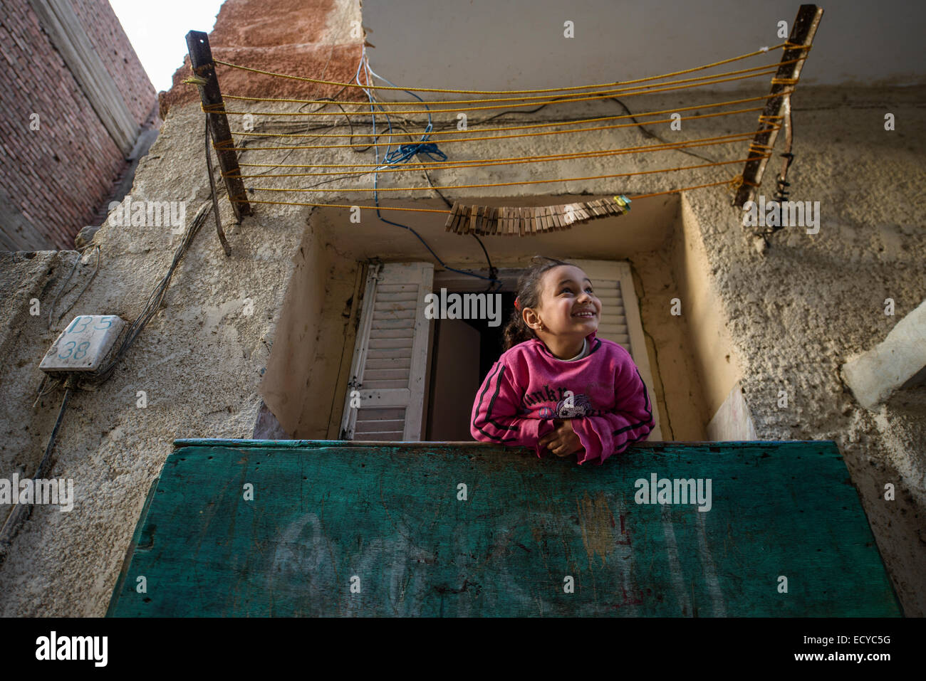 Girl looking out of window in Cairo, Egypt Stock Photo