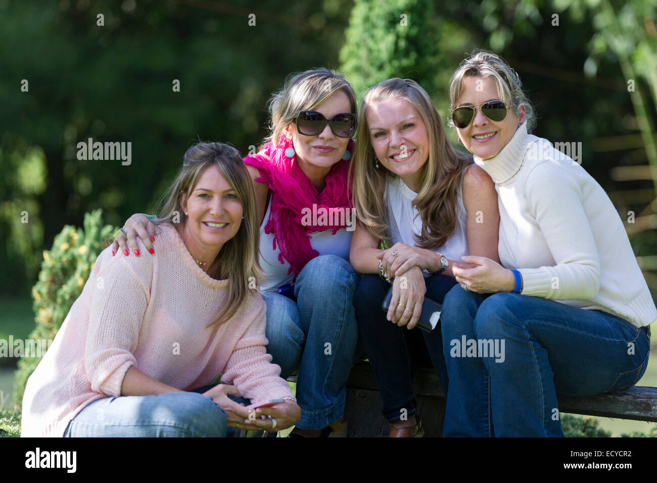 Smiling friends posing outdoors Stock Photo
