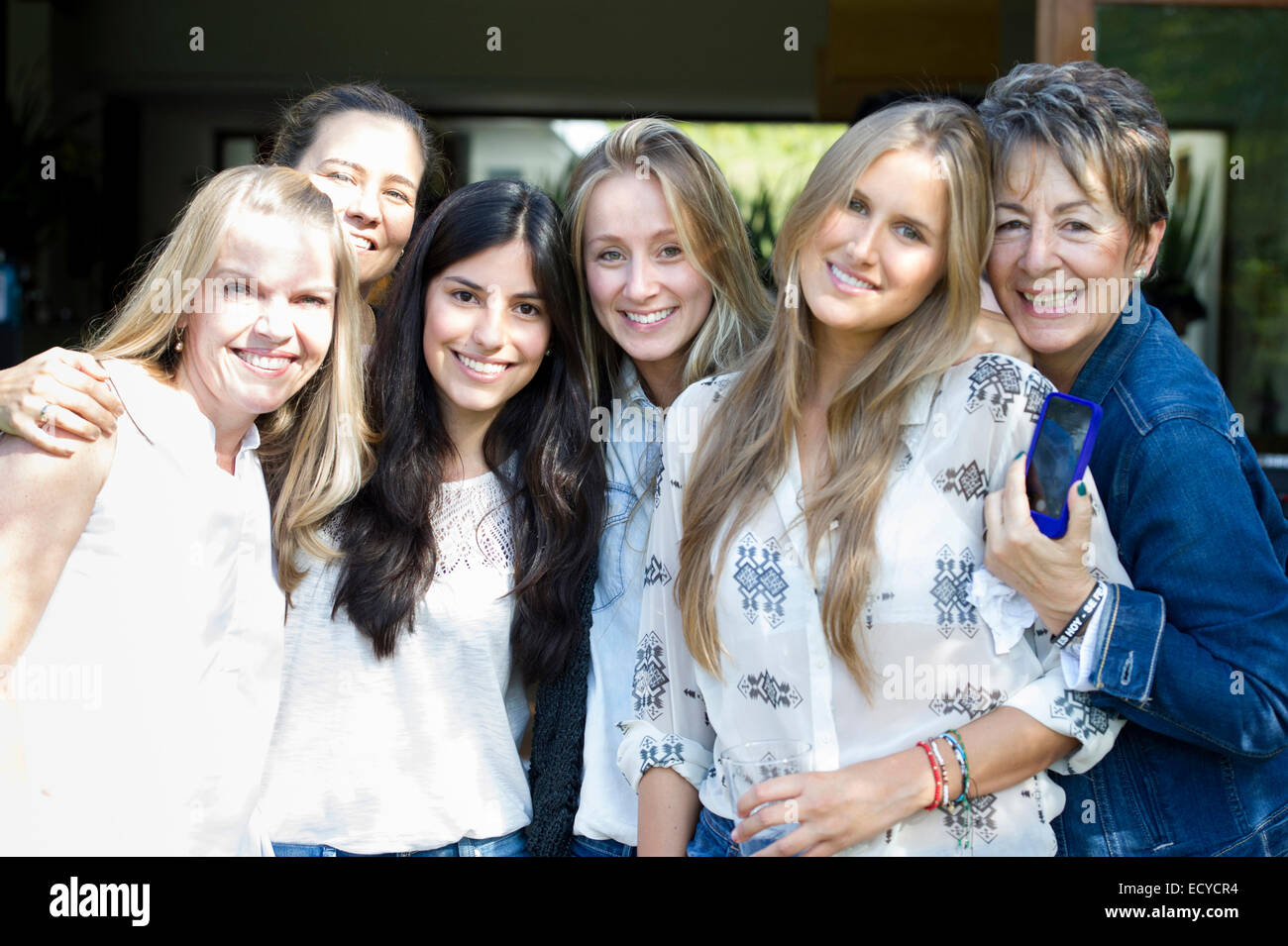 Smiling women posing at family reunion Stock Photo