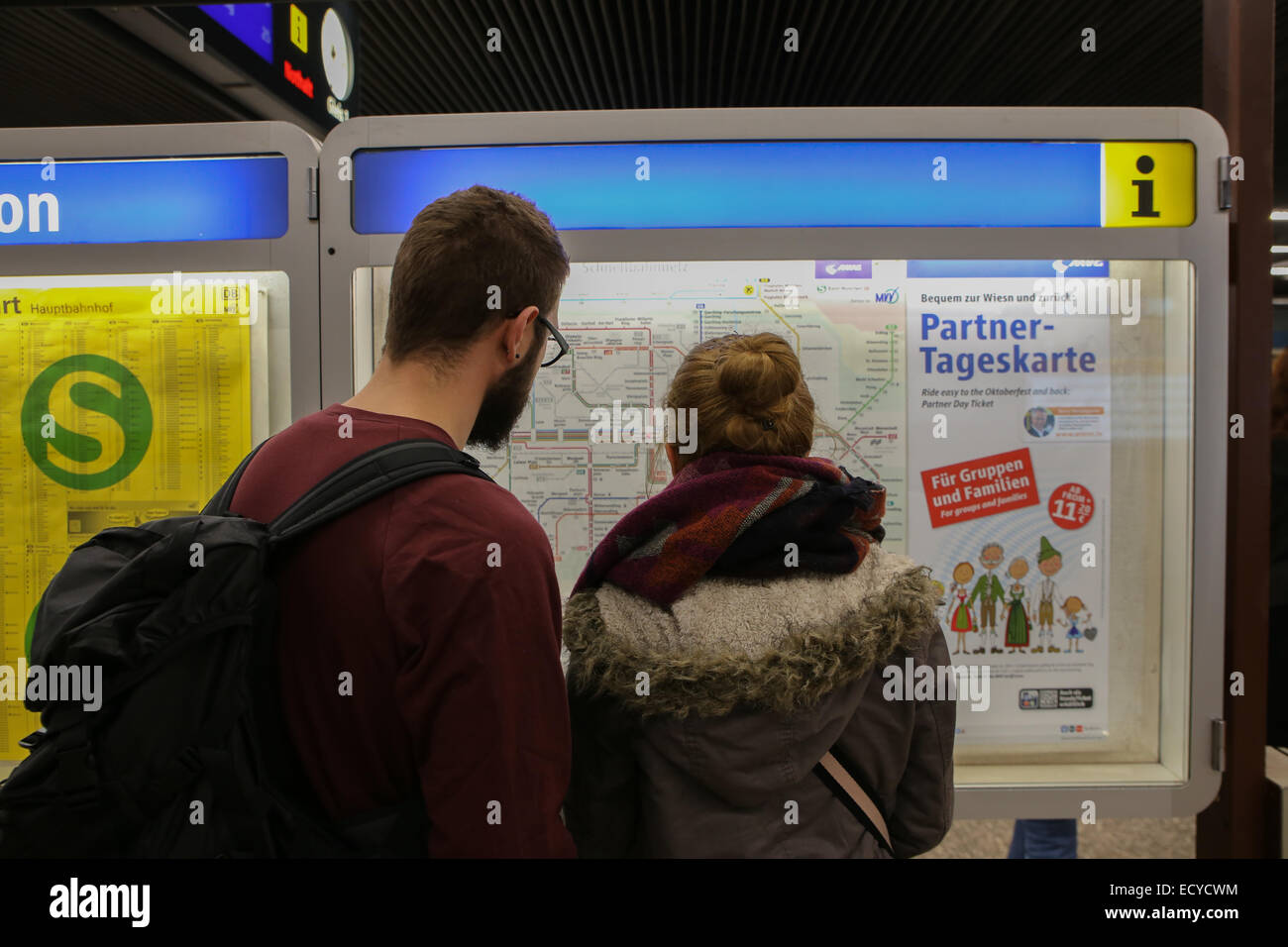 man woman checking metro subway map munich germany europe Stock Photo