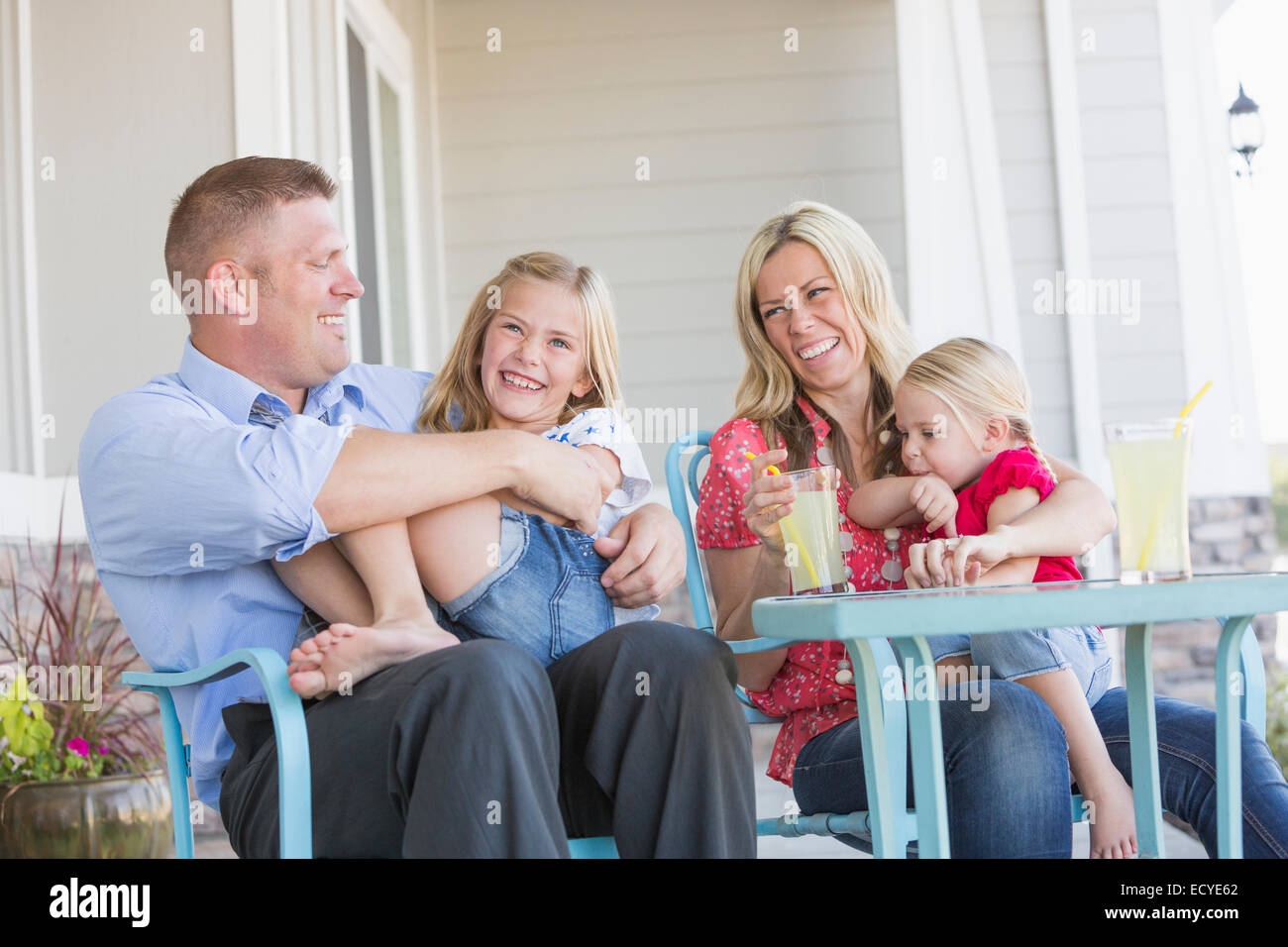 Caucasian family sitting on porch Stock Photo