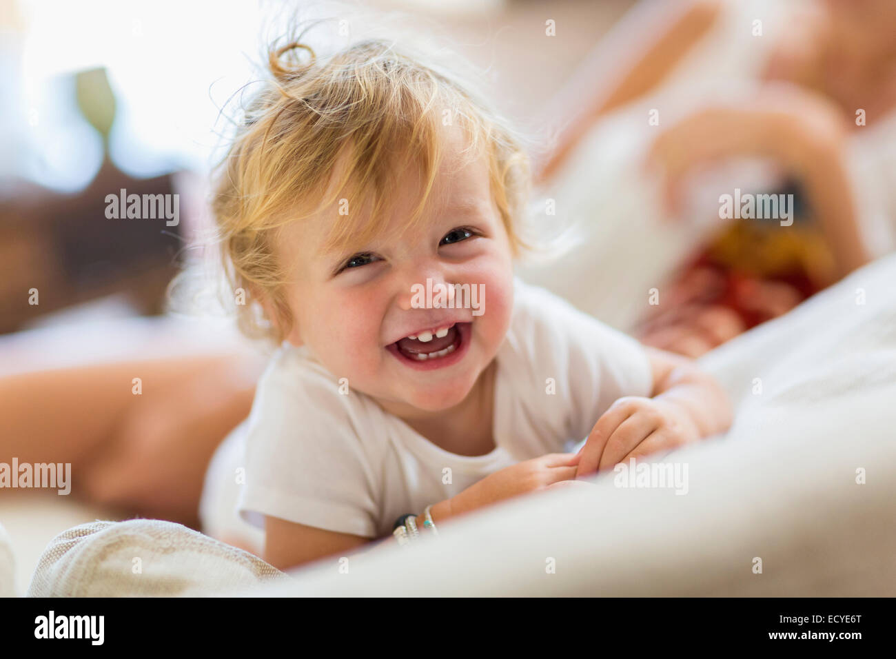 Caucasian toddler boy laughing on sofa Stock Photo