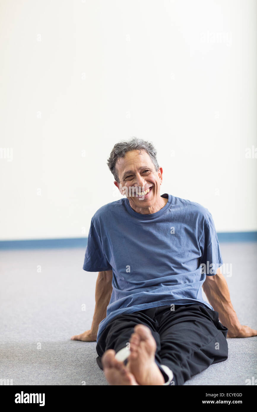 Senior Caucasian man smiling on floor Stock Photo - Alamy