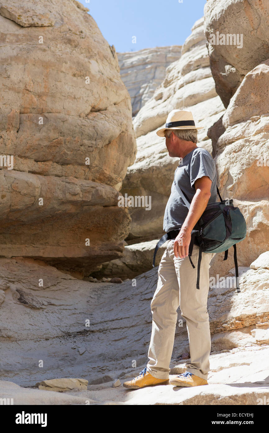 Older Caucasian man exploring rock formations Stock Photo