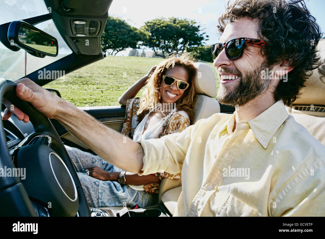 Couple driving together in convertible Stock Photo