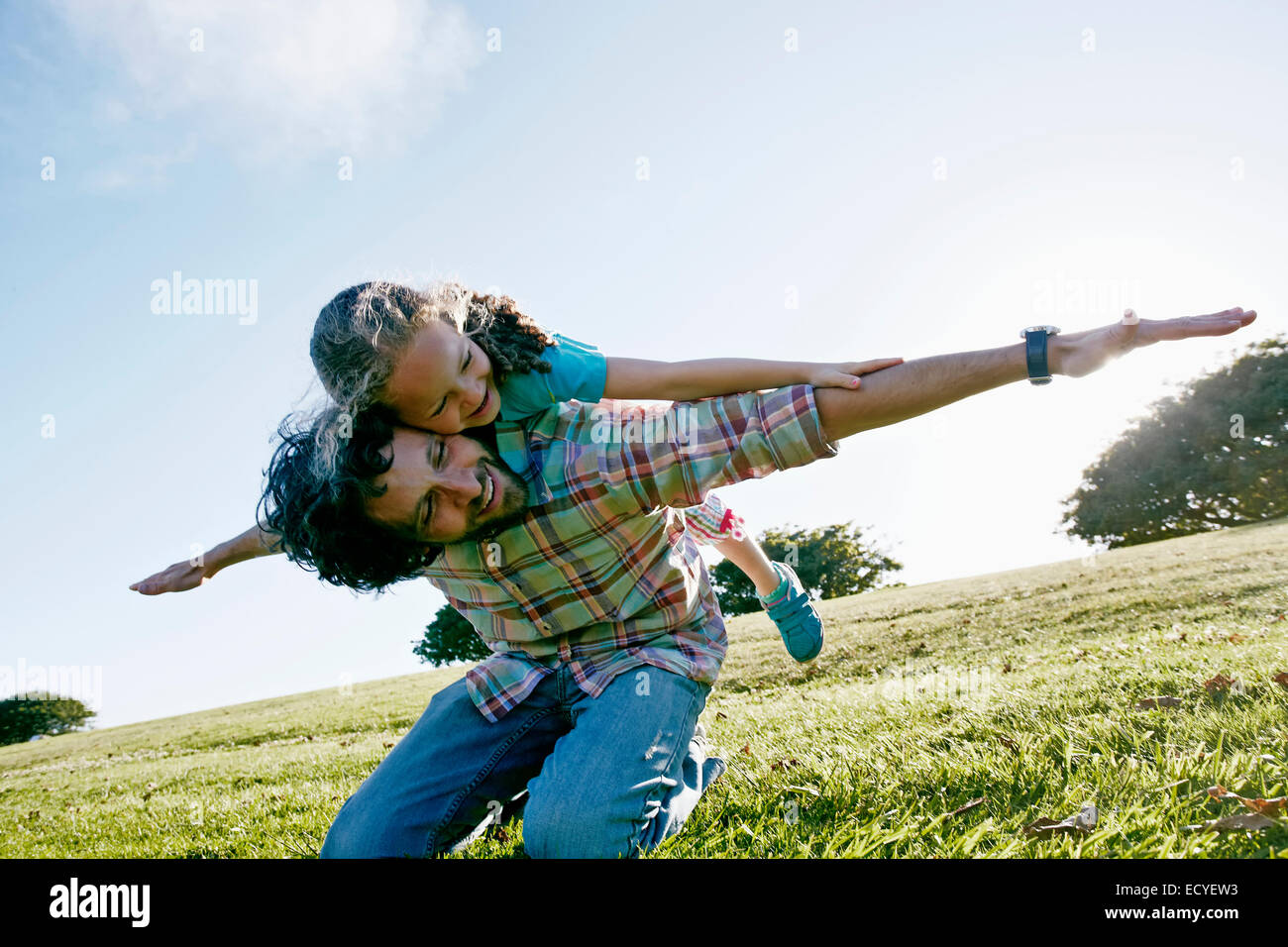 Father and daughter playing outdoors Stock Photo
