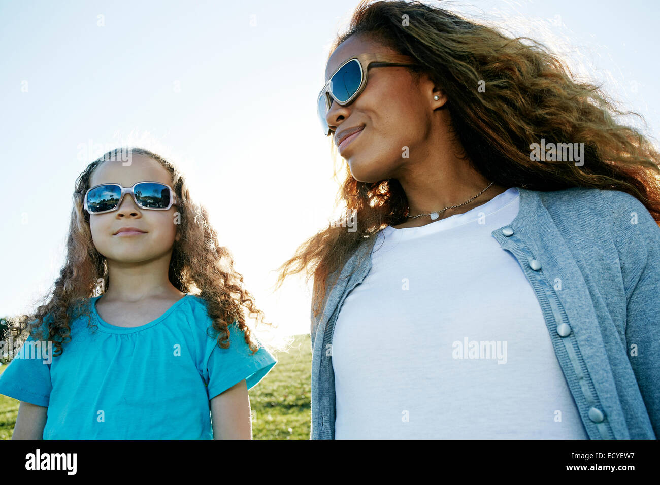 Mother and daughter wearing sunglasses outdoors Stock Photo