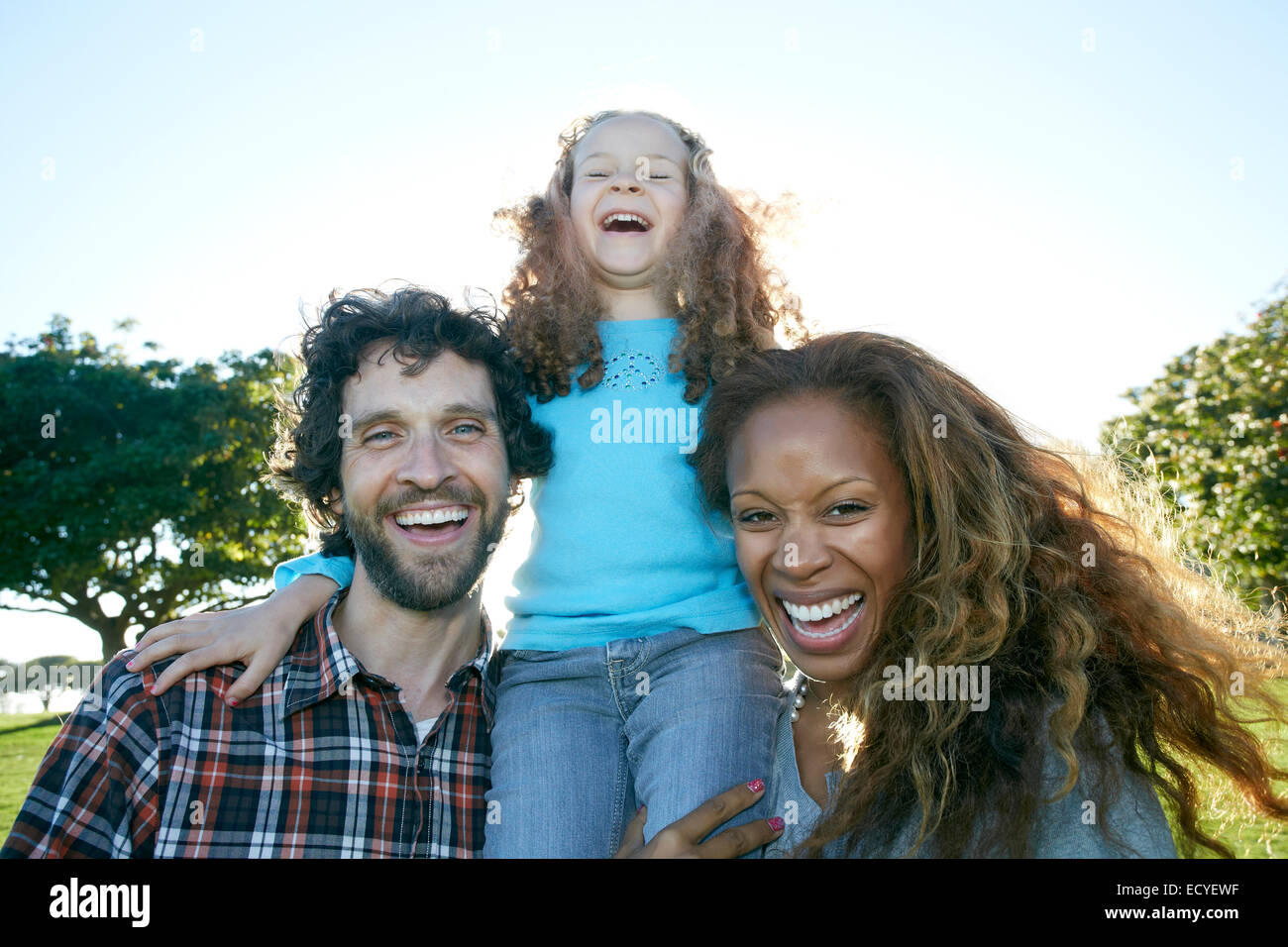 Family laughing together outdoors Stock Photo