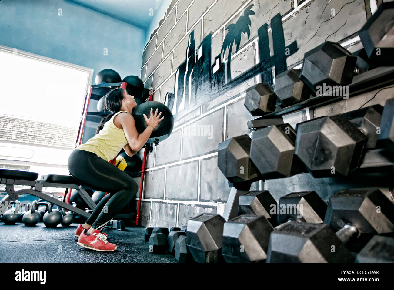 Hispanic woman exercising in gym Stock Photo