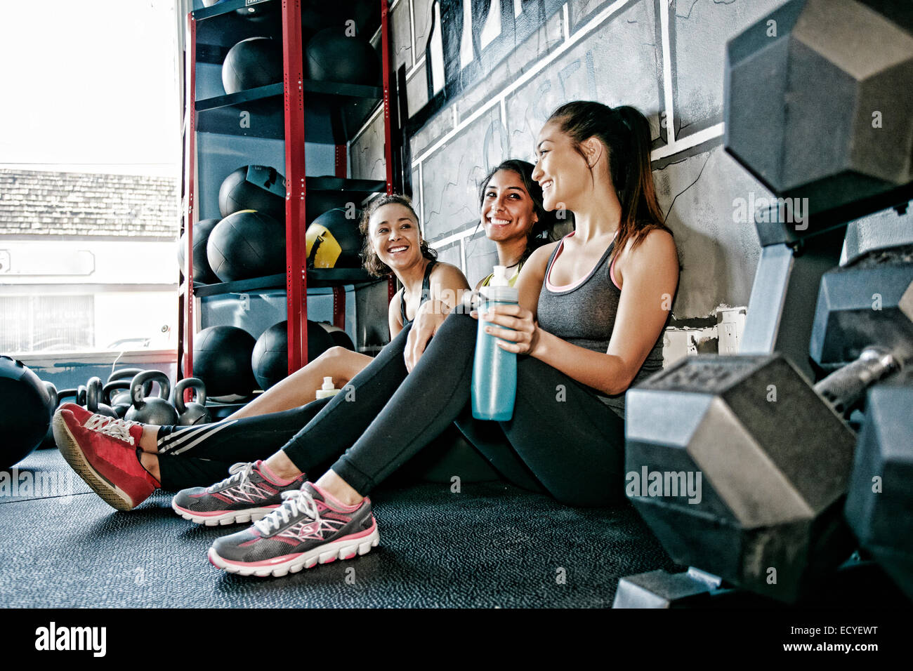 Women resting together in gym Stock Photo