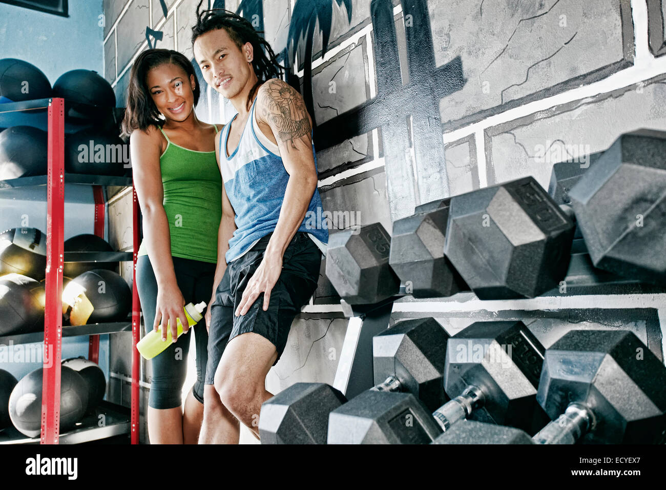 Couple smiling together in gym Stock Photo - Alamy