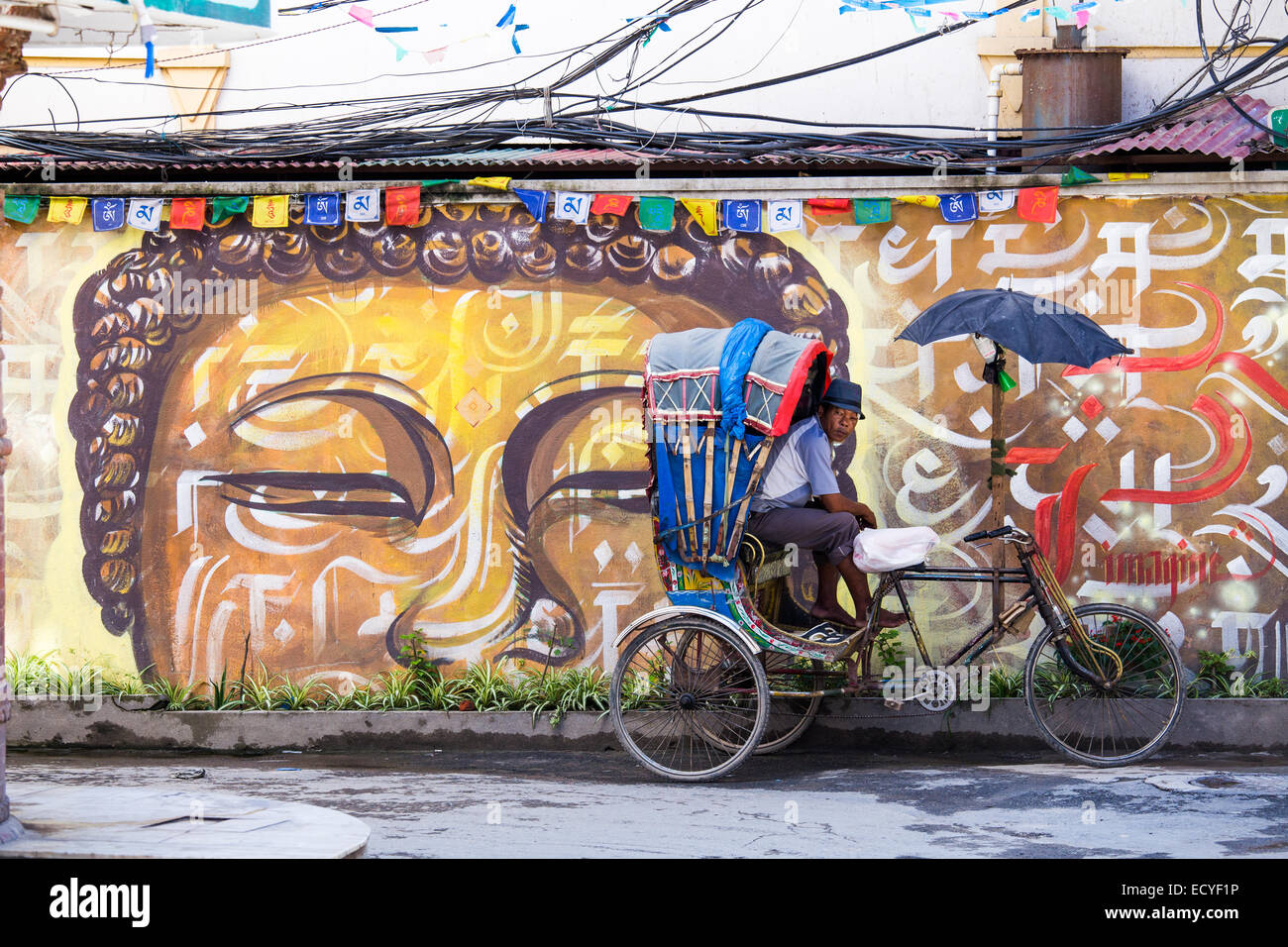 Cycle rickshaw in front of wall arta in Thamel, Kathmandu, Nepal Stock Photo