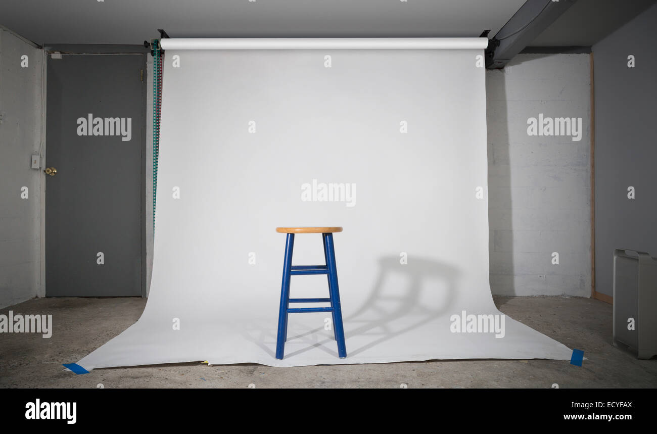 Simple stool on sweep in studio Stock Photo