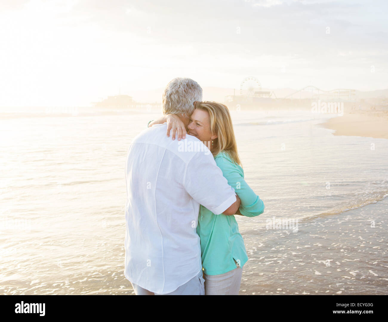 Caucasian couple hugging on beach Stock Photo