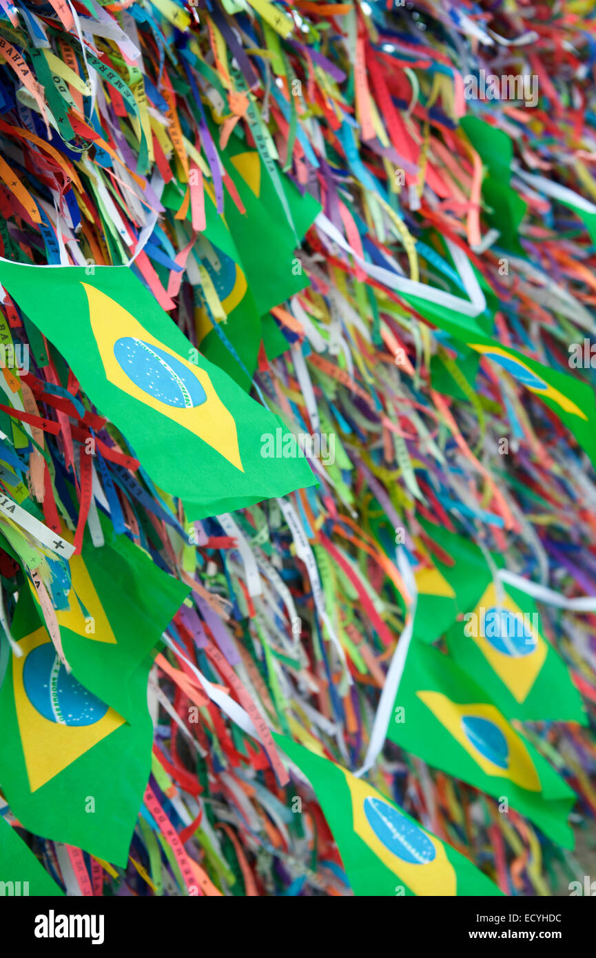 Brazilian flags flying on a wall of wish ribbons at the famous Church
