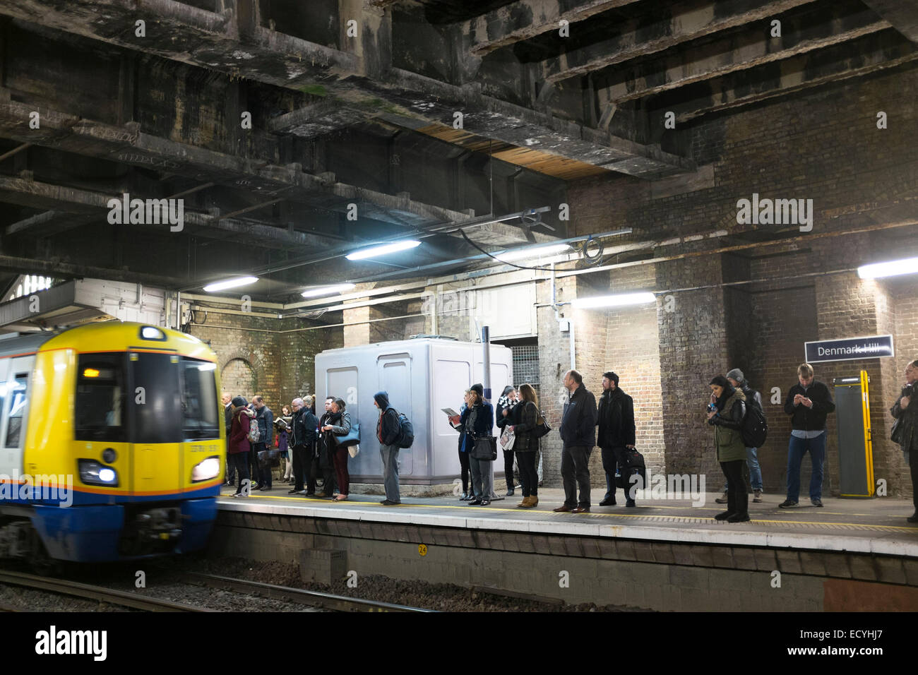 Commuters waiting for Overground train during rush hour at Denmark Hill station,  London, UK. Stock Photo