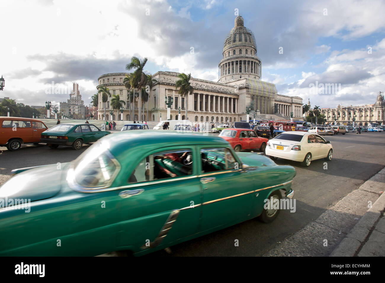 Classic cars driving next to the National Capitol Building in  Havana, Cuba Stock Photo