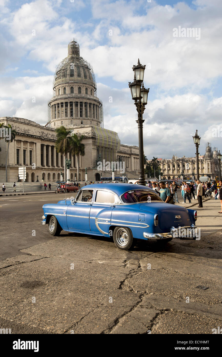 Classic cars driving next to the National Capitol Building in  Havana, Cuba Stock Photo