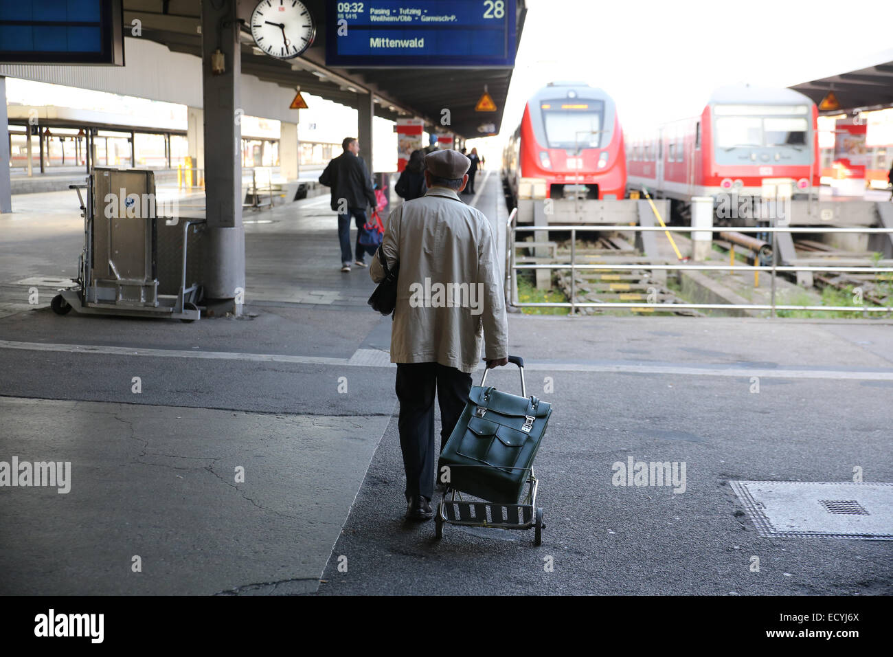 old man rolling luggage train travel Europe Stock Photo
