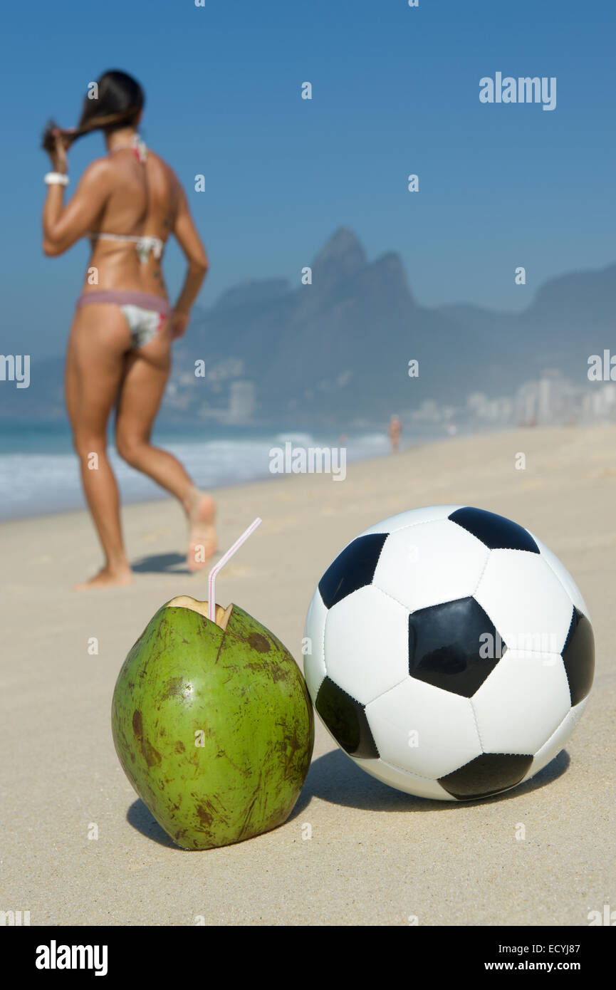 Brazilian woman in bikini walks past fresh green drinking coconut coco