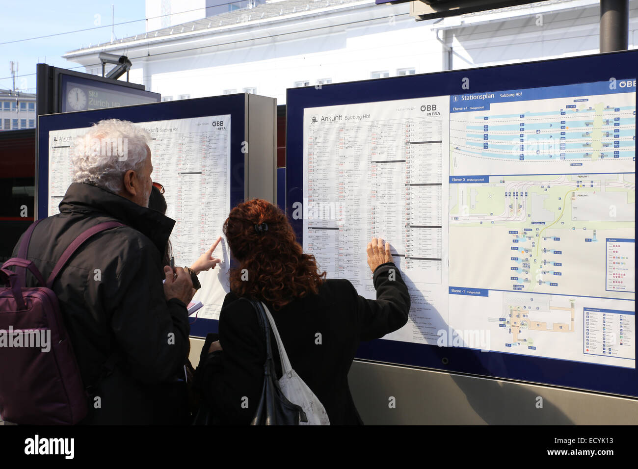 people checking train schedule Europe Stock Photo