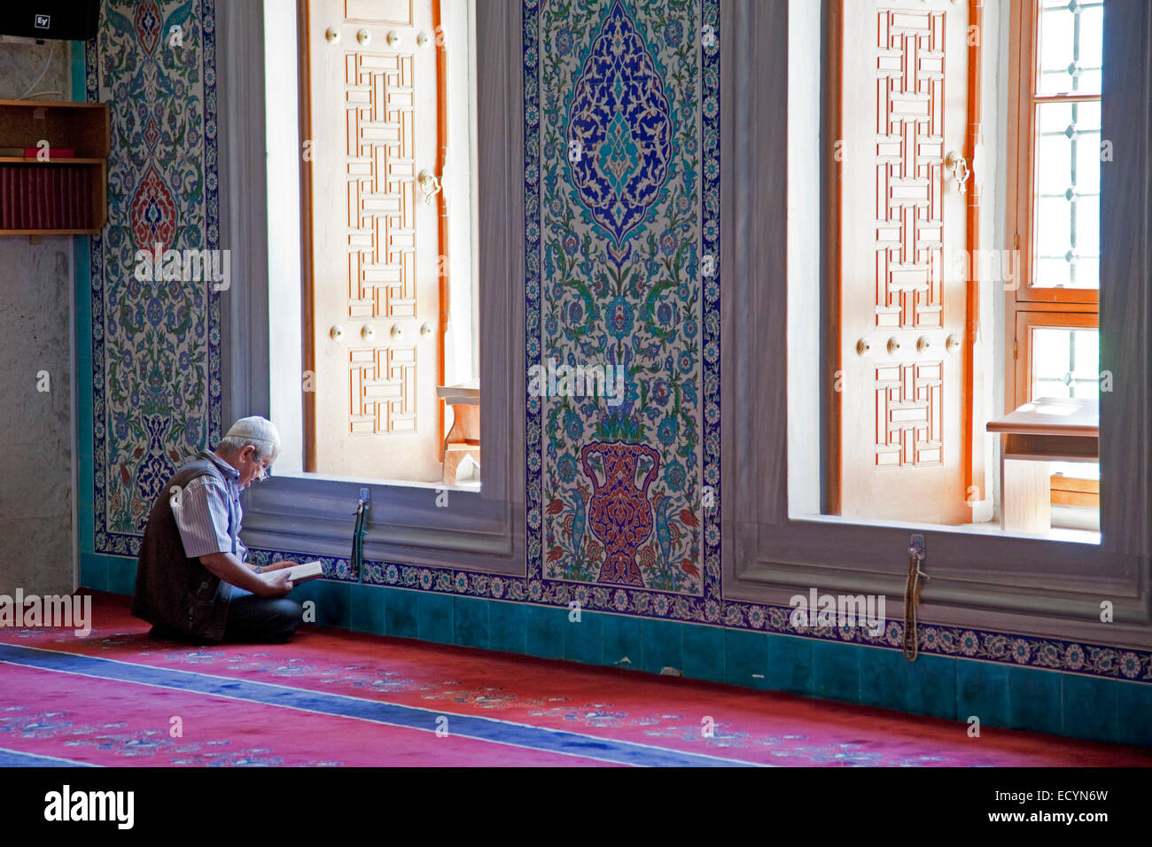 Turkish man reading the Koran in the Kocatepe Camii, largest mosque in Ankara, Turkey Stock Photo
