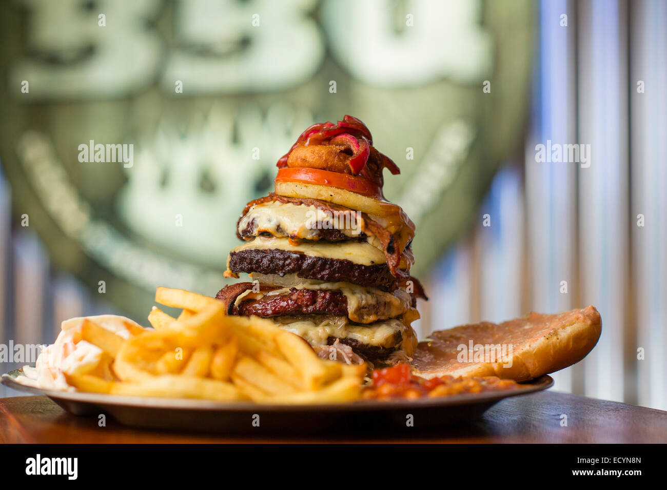 A monster multilayered highcalorie fattening huge meal of 4 four hamburgers cheeseburgers beef