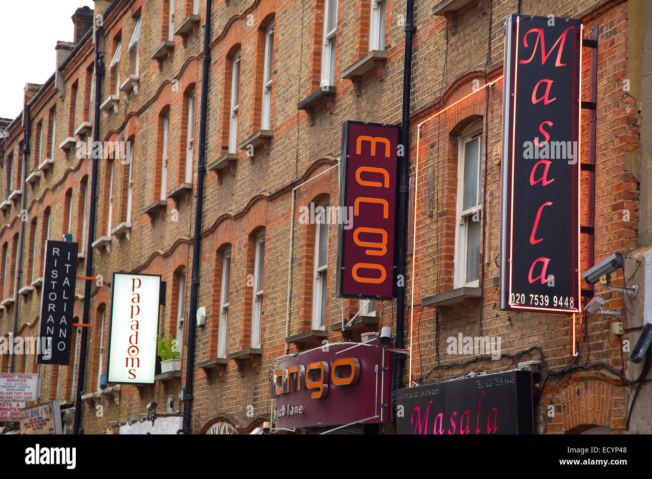 LONDON - OCTOBER 18TH: Restaurant signs on Brick lane on October 18th, 2014 in London, england, uk. Brick lane is a culinary att Stock Photo
