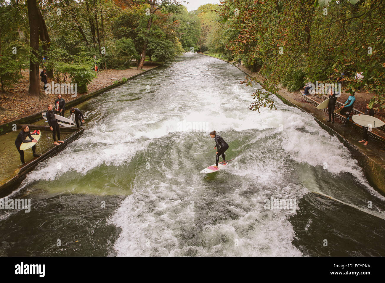 Munich surfers outdoor Eisbach Wave man made river Stock Photo