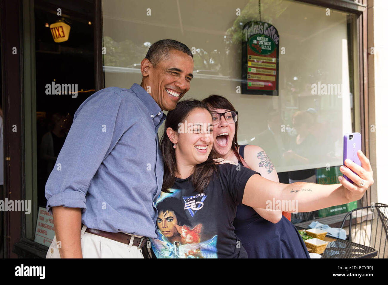 President Barack Obama poses for a picture at Magnolia’s Deli & Café during the college affordability bus tour, in Rochester, N.Y. , Aug. 22, 2013. Stock Photo