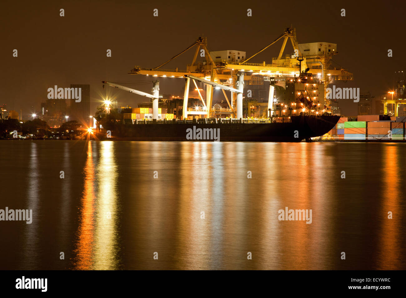 Big Container Cargo freight ship with working crane in shipyard at ...